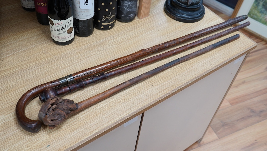 A swordstick and two other walking canes. Condition - fair